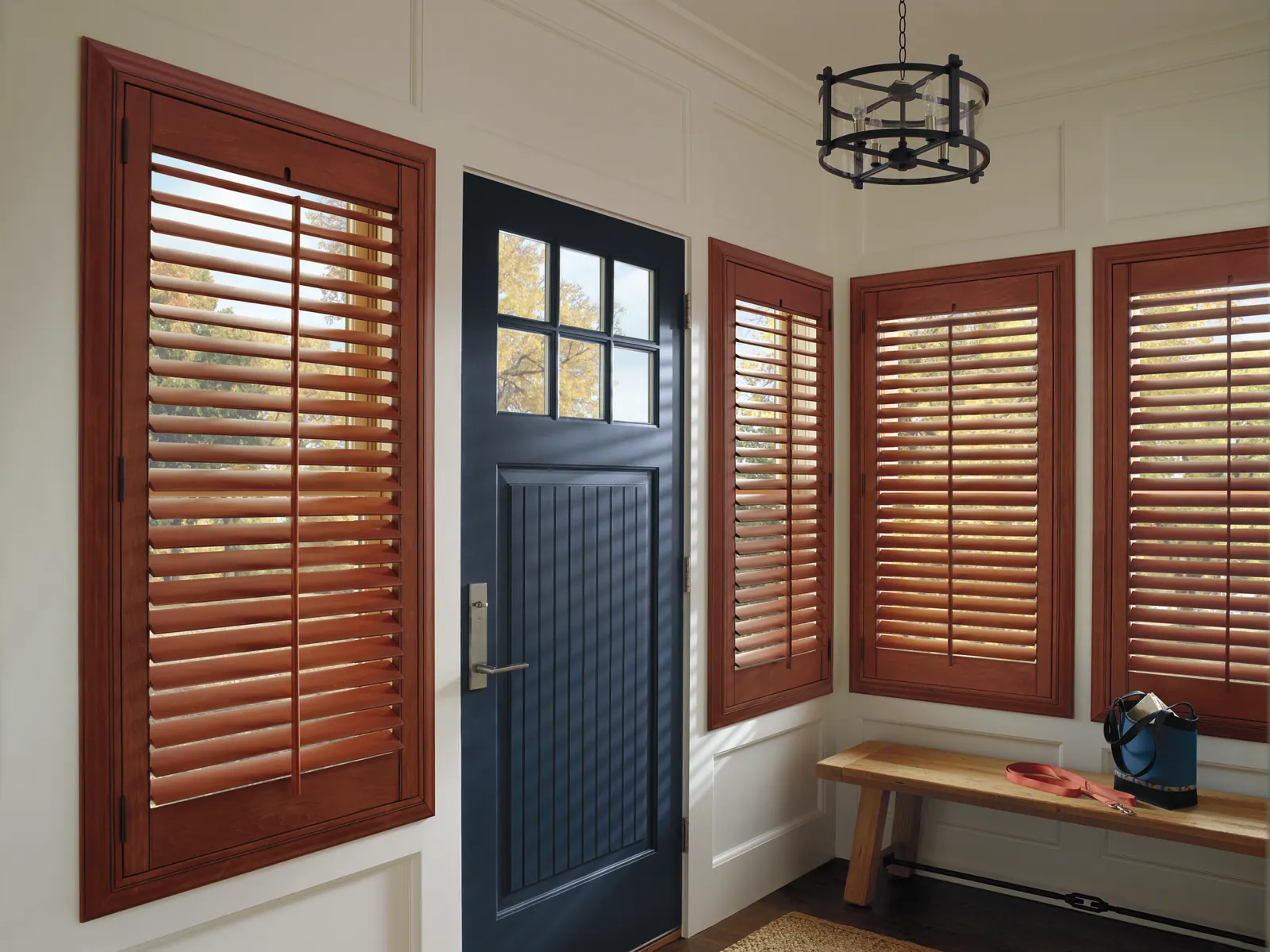 Glazed hardwood plantation shutters framing an entryway window