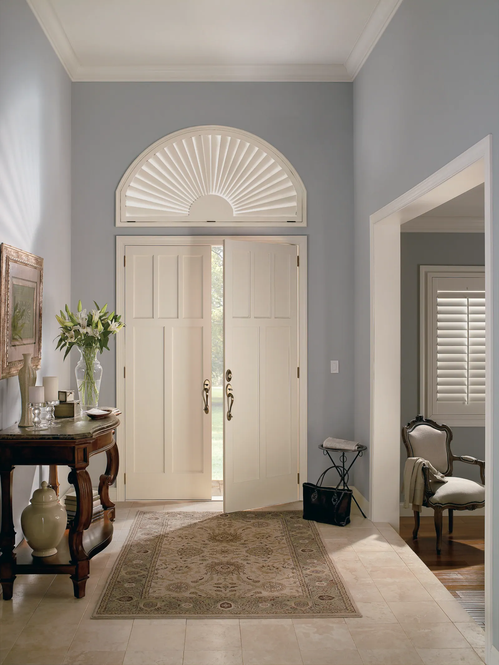 Specialty eyebrow-shaped composite shutters above an entry door
