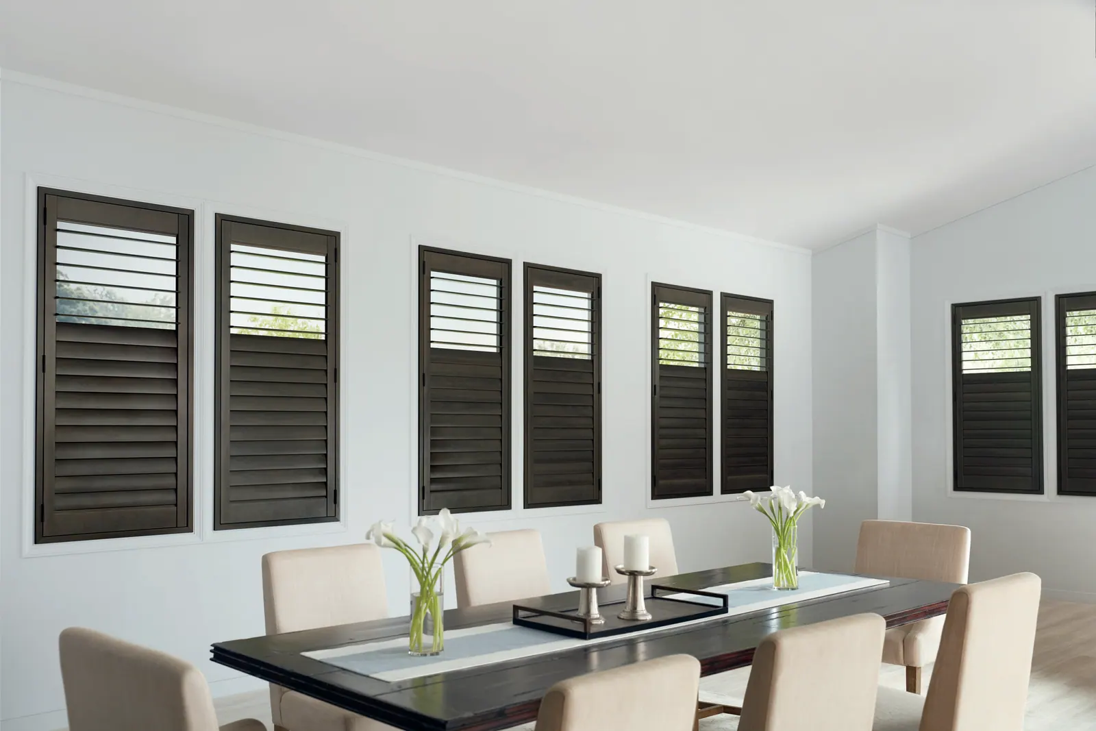 Split-tilt composite shutters in a dining room