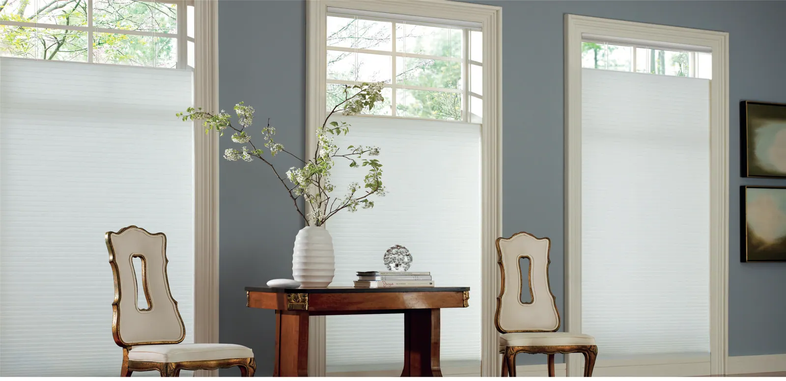 Motorized top-down bottom-up shades under an arched window in a den