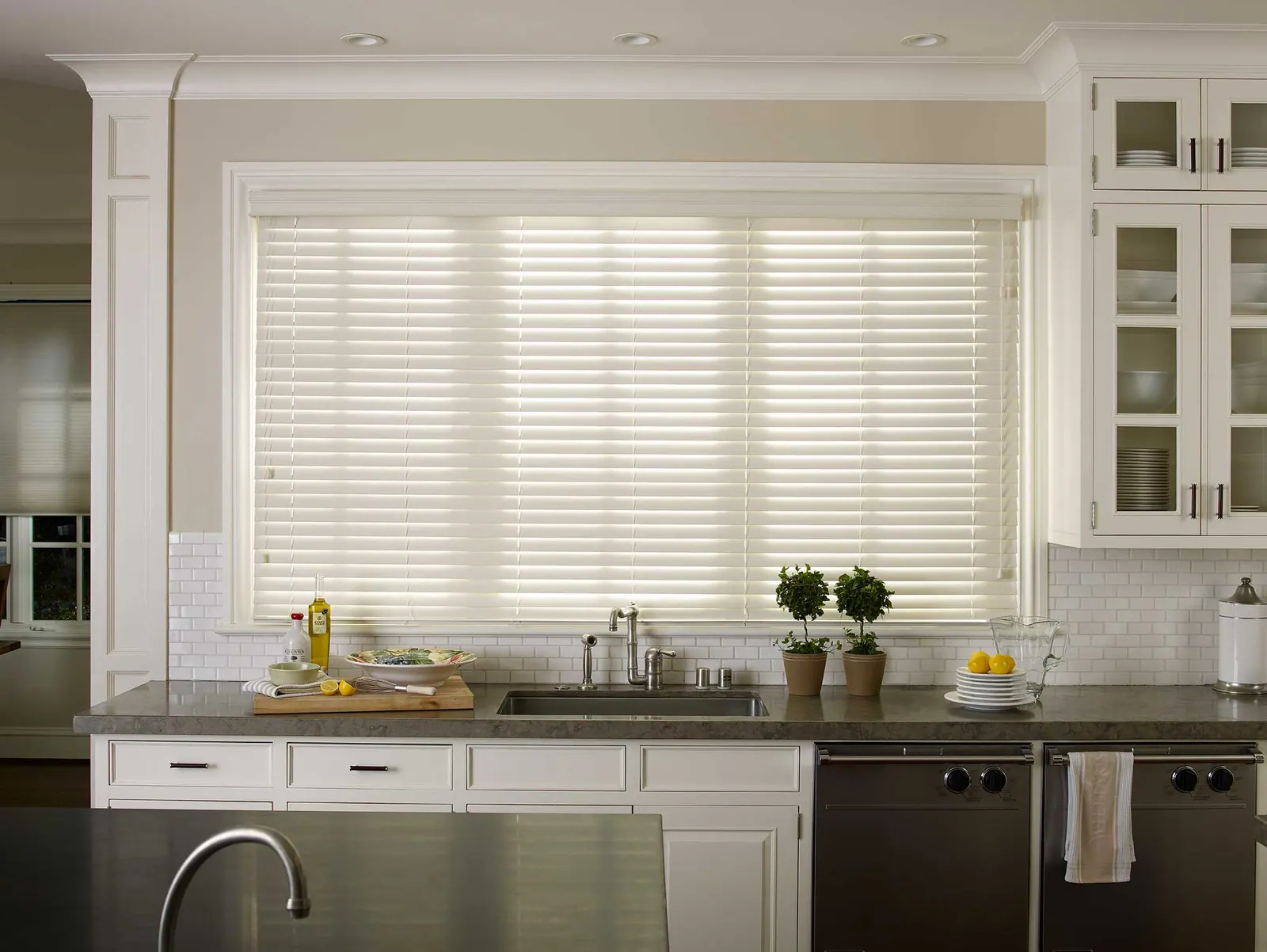 White faux wood blinds in a bright room