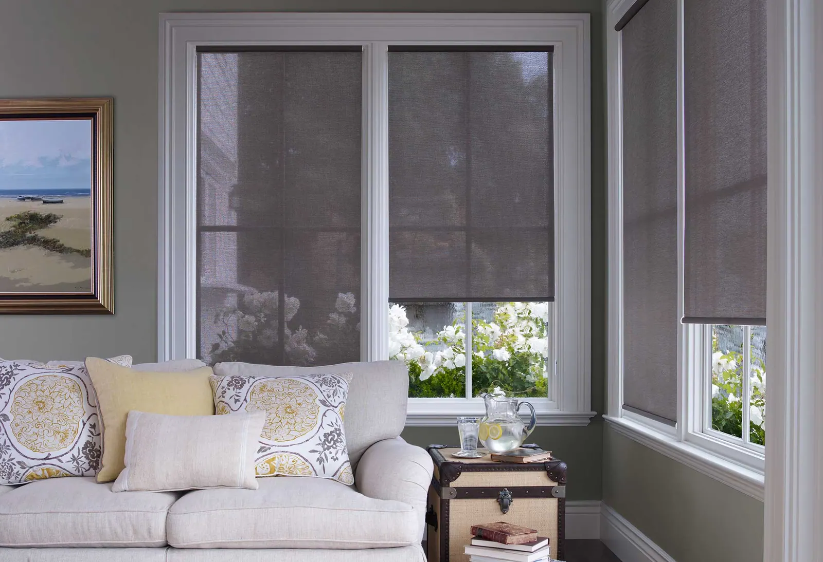 Solar screens over a living room window with mountain light behind