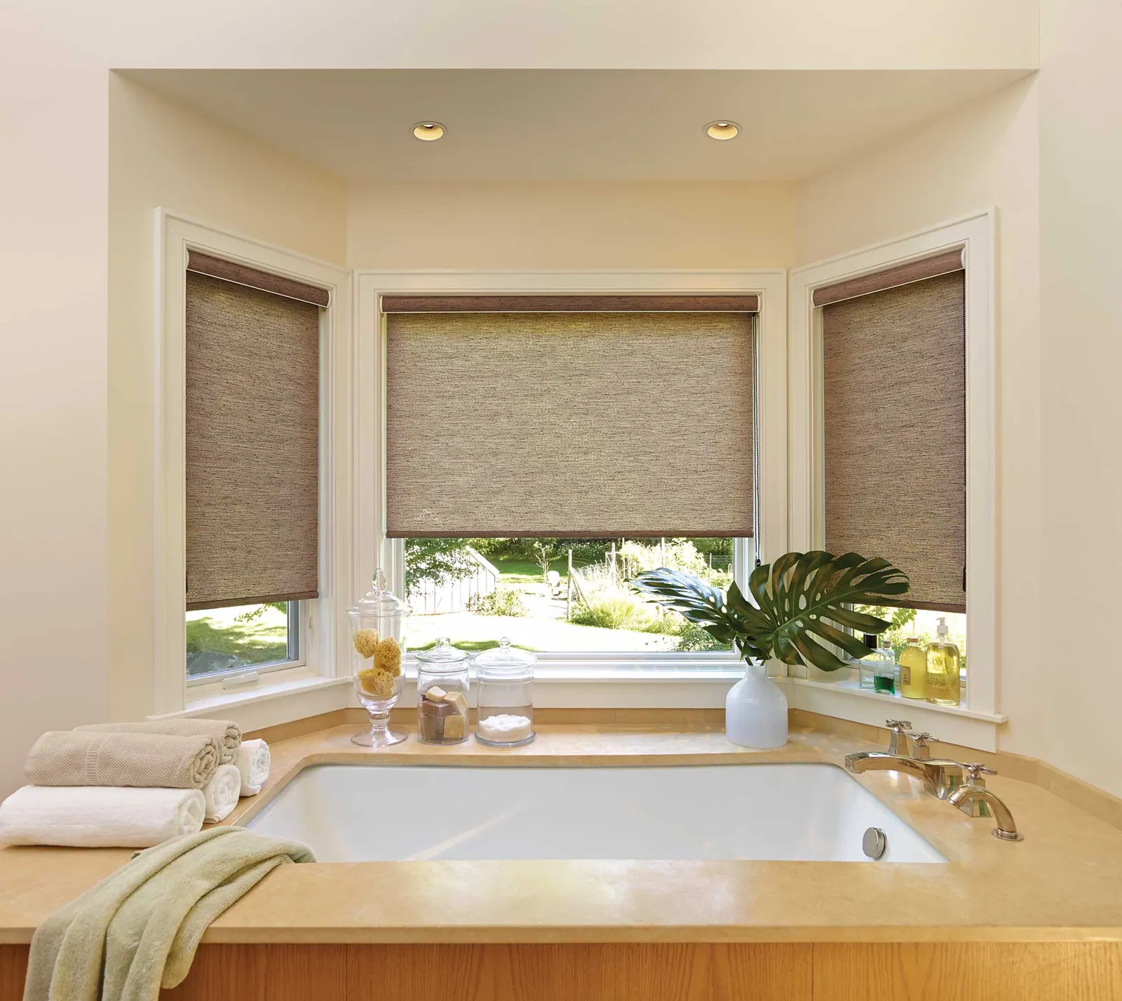 Plantation shutters across a wide living room window wall